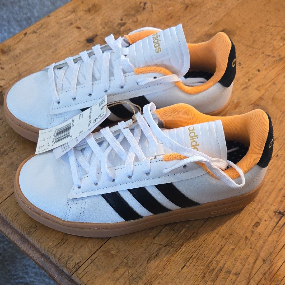 Adidas Women's size 6/Men's 4 1/2 White and Black Sneakers with Orange Accents